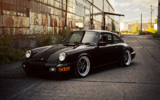 Black porsche building bushes sunset - refined free wallpaper