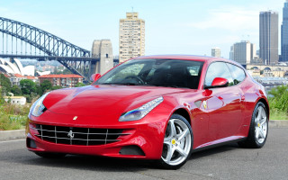Red sports car bridge city - feature free wallpaper