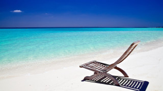 Beach chair ocean blue sky - a white sand beach free wallpaper