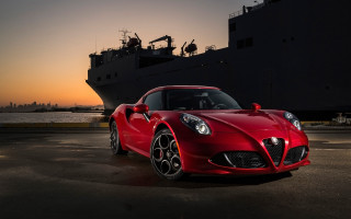Red sports car ship sunset - a boat in the background free wallpaper