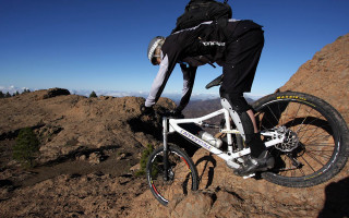 Man riding mountain bike rocky - biomechanical free wallpaper