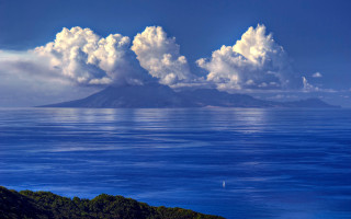 Mountain ocean water boat sky - a large body of water free wallpaper