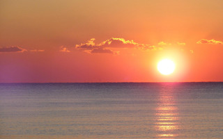 Sunset ocean boat sailboat city - a sunset over the ocean free wallpaper