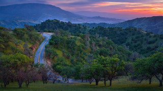 Winding road lush green hillside - both side of it free wallpaper