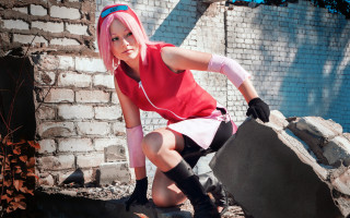 Pink hair woman leaning brick - a brick wall behind her free wallpaper