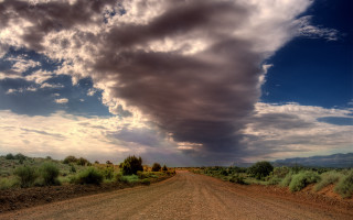 Dirt road cloud sky mountains - stormy weather free wallpaper