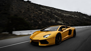 Yellow sports car driving mountain - a yellow sports car free wallpaper
