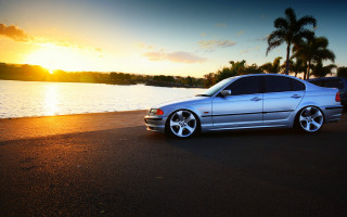 Silver car beach sunset palm - the side of a road near a body of water free wallpaper
