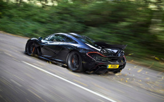 Black sports car driving forest 4 - a forest of trees and bushes free wallpaper