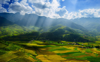 Valley mountains sunrays clouds blue 3 - a view of a valley free wallpaper