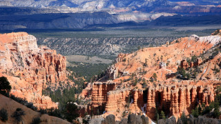 Mountain range valley distant snow - a view of a mountain range free wallpaper