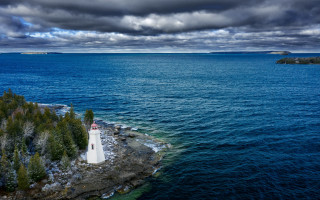 Lighthouse island ocean cloudy sky - a lighthouse free wallpaper