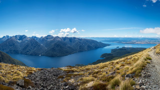Mountain lake panorama blue sky - a view of a mountain range free wallpaper