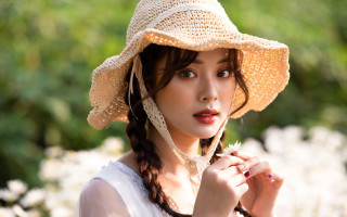 Woman strawhat flower serious portrait - a flower free wallpaper