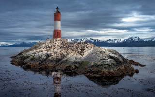 Lighthouse rock ocean mountains cloudy - a rock in the middle of the ocean free wallpaper