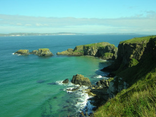 Rocky shore green grass cliff - a view of a body free wallpaper