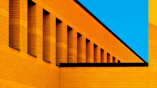 Yellow building clock blue sky - a yellow building free wallpaper