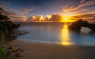 Sunset beach rock formation magic - crepuscular ray free wallpaper