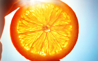 Orange slice photorealism fire explosion - a person holding free wallpaper