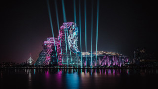 Large building city lights night - an abstract sculpture free wallpaper
