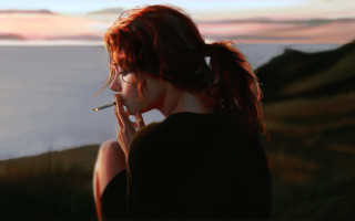 Woman smoking sunset water figurate - a cigarette in front free wallpaper