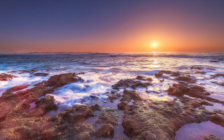 Sunset ocean waves rocks lighthouse 2 - a lighthouse in the distance free wallpaper