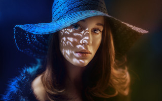 Woman bluehat shadow bluebackground portrait 2 - her face free wallpaper for desktop