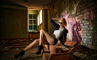 Gothic fashion blonde boot sitting - a brick wall free wallpaper