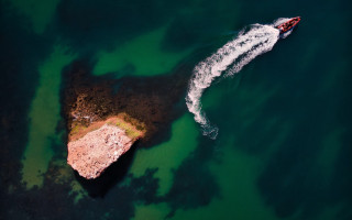 Boat rocks ocean tiltshift aerial - aerial free wallpaper