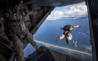 Military man flying stuffed animal - cliff childs free wallpaper