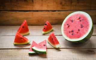 Watermelon halves fruit wooden table - a wooden table free wallpaper