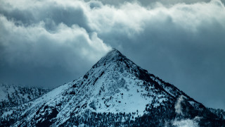 Snowy mountain trail cloudy sky - the side of it free wallpaper
