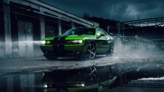 Green car puddle building dark - a dark sky in the background free wallpaper