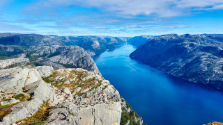 Lake cliff mountains people sky - a view of a lake free wallpaper