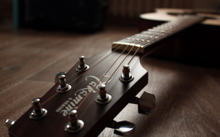 Guitar neck wooden floor blurry - a close up of a guitar neck free wallpaper