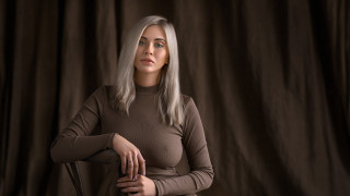 White haired woman brown shirt - grey background free wallpaper