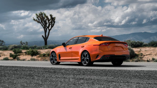 Orange sports car desert road - a road in the desert free wallpaper