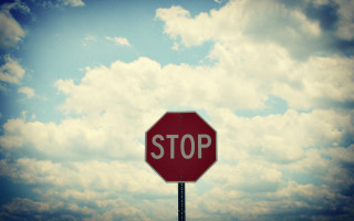 Stop sign sky clouds cityscape - a stop sign free wallpaper