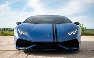 Blue sports car cloudy sky 2 - a parking lot free wallpaper