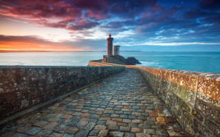 Stone lighthouse rocky shore sunset - a stone walkway free wallpaper