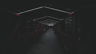 Long walkway red light dark - the end of it free wallpaper