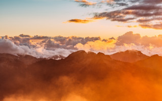 Mountain range plane clouds sunset - a plane in the foreground free wallpaper
