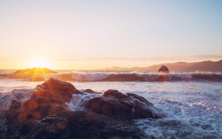 Sunset ocean waves rocks mountains - a sunset over the ocean free wallpaper