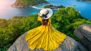 Woman yellow dress hat ocean 2 - a small island free wallpaper