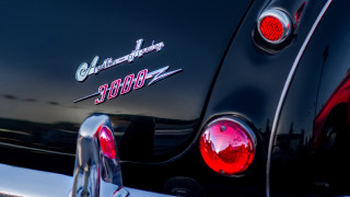 Black car red tail light - a black car free wallpaper