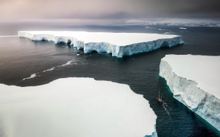 Boat icebergs ocean mountain sky - a boat free wallpaper