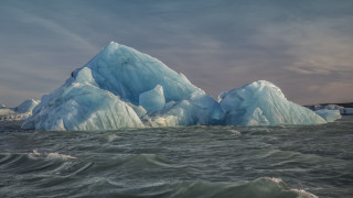 Iceberg ocean waves cloudy sky - front of it free wallpaper