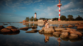 Woman rock lighthouse reflection cinematic - a reflection free wallpaper
