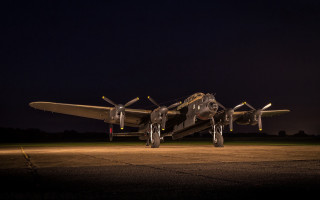 Large airplane runway night lights - wing and a propeller free wallpaper