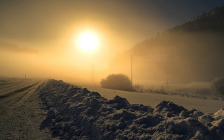 Snowy road foggy sunrise mountains - volumetric fog free wallpaper